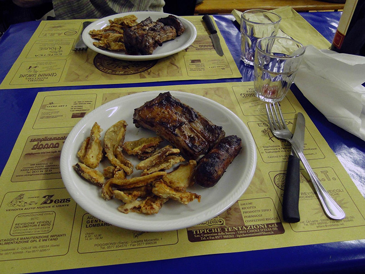 Fried Porcini mushrooms with grilled meat in Pievescola