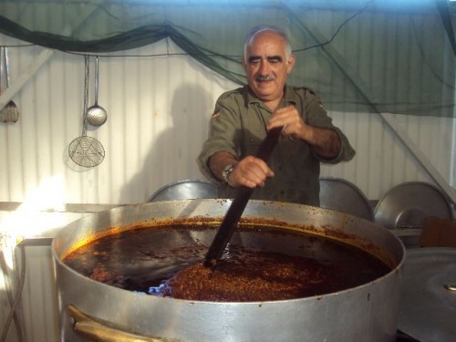 The staff of the festival while preparing wild boar sauce